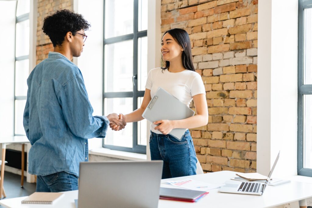 A sales intern shakes hands with her manager during her internship.